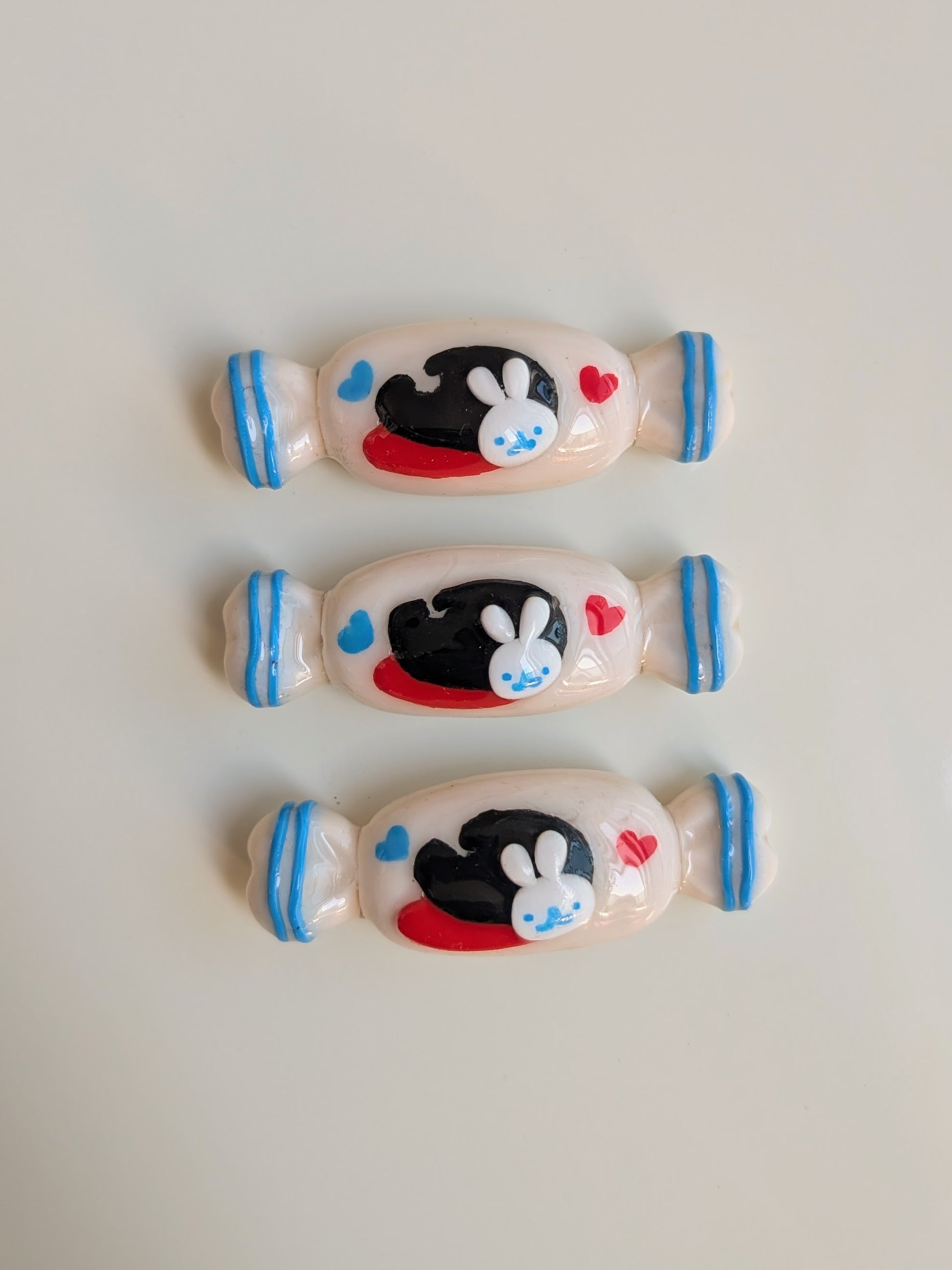 Three cartoon character candies on a light gray background